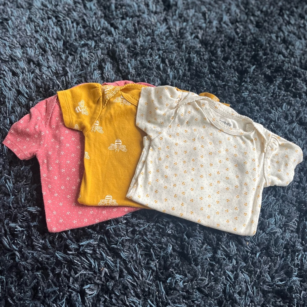 Set of Three Baby Onesies in Pink, Yellow, and Cream